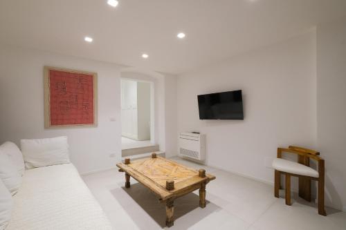 a living room with a couch and a table at Old Stone House in Bari