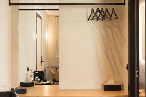 a kitchen with a wall with hangers on it at AthensOwl in Athens