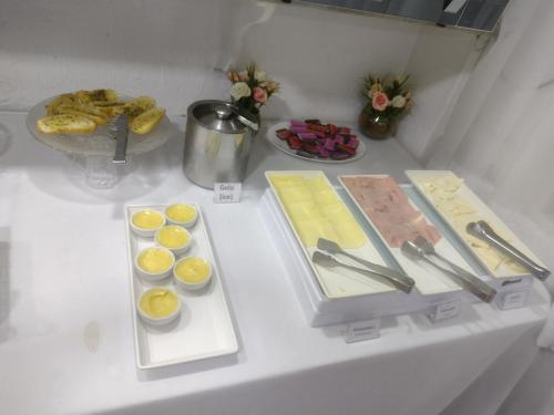 a white table with some food on it at Mônaco Hotel in Juiz de Fora