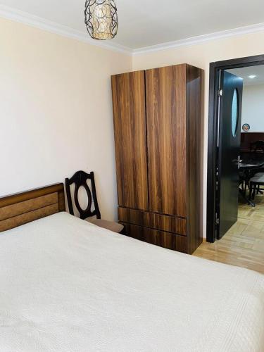 a bedroom with a bed and a cabinet and a table at Надежда in K'obulet'i