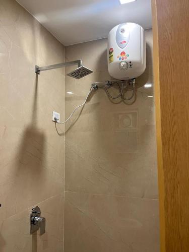 a bathroom with a shower with a camera on the wall at Hotel Royal Casa in Lucknow