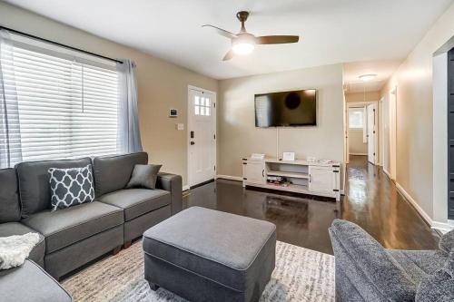 a living room with a couch and a tv at Charlotte Charm Haven with Outdoor TV in Charlotte
