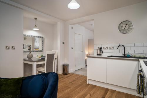 a kitchen and a living room with a counter top at Coppergate Mews Doncaster Apartment 3 in Doncaster