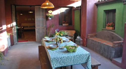 a table with a blue table cloth in a room at Case Vacanze Fossanave in Santa Tecla