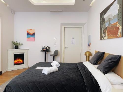 a bedroom with a black bed with a fireplace at CASA IVH BNB in Florence