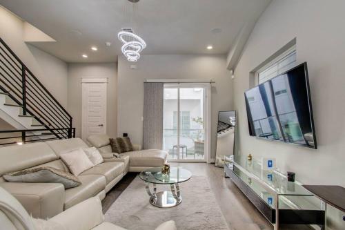 a living room with a couch and a tv at Luxurious Med Cntr/NRG Townhome in Houston
