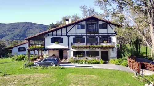 ein Haus mit einem davor geparkt in der Unterkunft Casa Rural Maidanea in Hondarribia