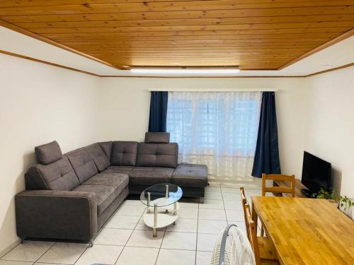 a living room with a couch and a table at Matten Central Residences in Matten