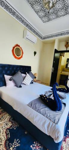 a bedroom with a bed with a swan on it at Riad Amazing in Marrakech