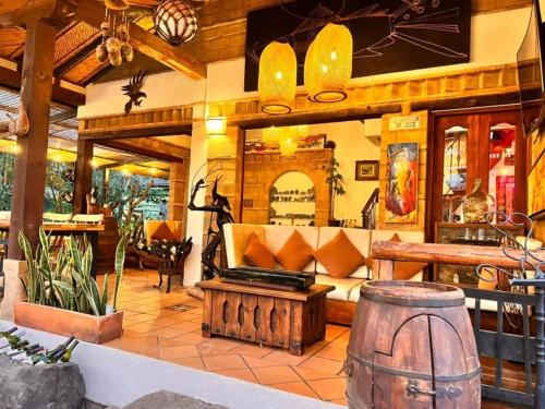 a living room with a couch and a barrel at Hotel Casa Cantabria Campestre in Villa de Leyva