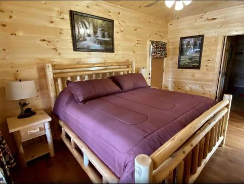 a bedroom with a bed in a log cabin at Country Memories in Sevierville