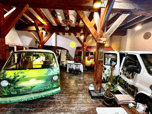 a car parked in a garage next to two vans at Urban Van Glamping Riga in Rīga