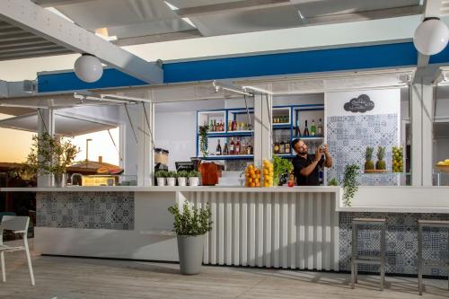 a man taking a picture of a bar in a restaurant at Parco Della Gallinara in Lido dei Pini