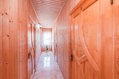 a hallway with wooden walls and a hallway with a hallway at ПІД МАГУРОЮ in Pilipets