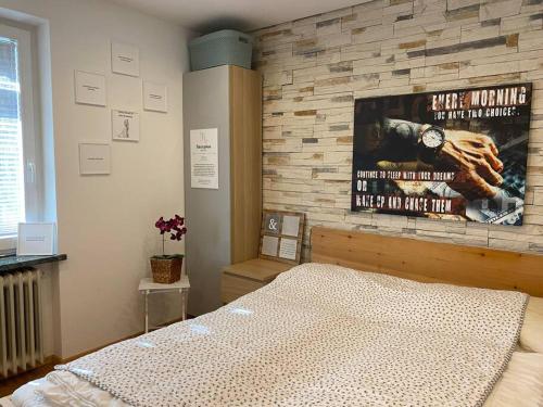 a bedroom with a movie poster on a brick wall at Apartment Reißeck in Penk