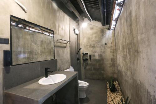 a bathroom with a sink and a toilet at Marika Resort in Badian