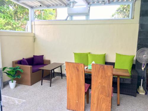a room with a table and chairs and a window at Villa Jalak Kembar in Canggu