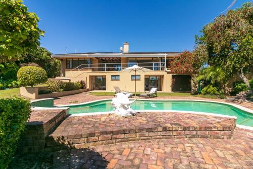 a house with a swimming pool in front of a house at Sand Castle in Sedgefield