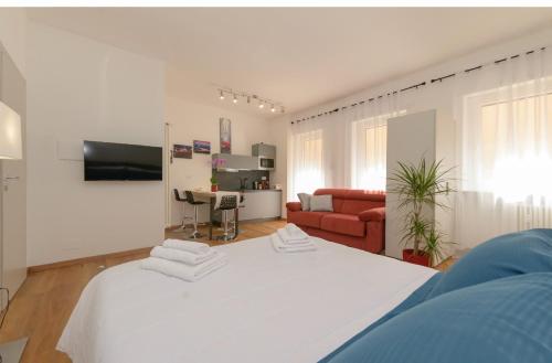 a large white bed in a living room with a couch at Royal Appartament in Turin