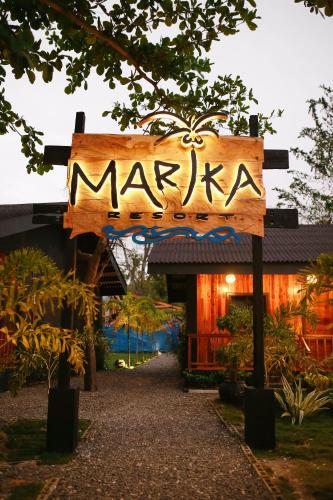 a sign for a marikina in front of a building at Marika Resort in Badian