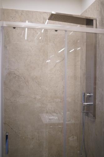 a shower with a glass door in a bathroom at La Resilienza Relais in Grumo Nevano