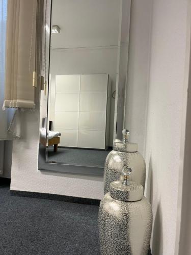 a bathroom with a mirror and two vases on the wall at Waldshut Stadt Ferien Wohnung in Waldshut-Tiengen