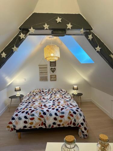 a bedroom with a large bed in a attic at République in Verberie