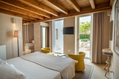 a bedroom with a bed and a large window at La Fiermontina Luxury Home Hotel in Lecce