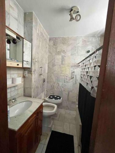 a bathroom with a sink and a toilet at Apartamento no Leblon in Rio de Janeiro