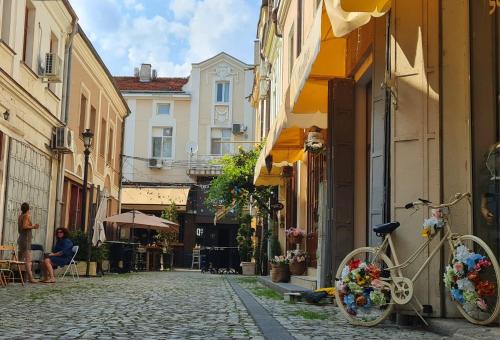 a bike parked on the side of a street at HANCHO - KAPANA CENTER PLOVDIV in Plovdiv