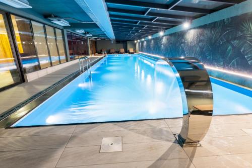 a large swimming pool in a building at Jazz Hotel in Tbilisi City