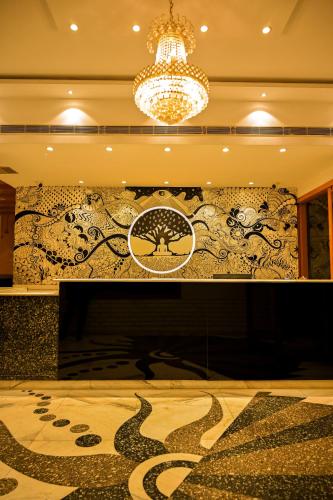 a fireplace in a room with a wall covered in graffiti at Trimrooms Buddha Varanasi in Varanasi