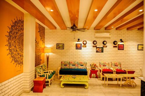 a restaurant with chairs and tables and a ceiling at Trimrooms Buddha Varanasi in Varanasi
