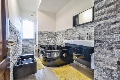 een badkamer met een wastafel en een stenen muur bij Secret Place Bologna in Bologna