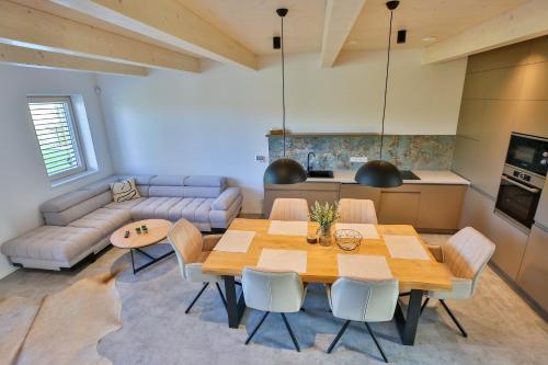 a living room with a table and a couch at Apartmány Lipno Přední Výtoň in Přední Výtoň
