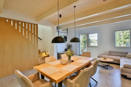 a dining room with a wooden table and chairs at Apartmány Lipno Přední Výtoň in Přední Výtoň