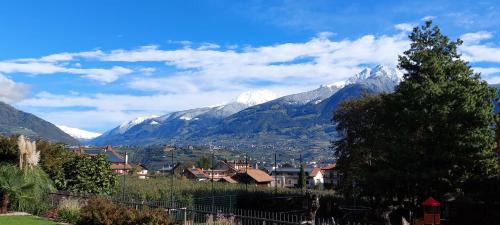 a view of a mountain range with a town and houses at Marlingsuites - Vinea - Wieser Josef - Marling in Marlengo