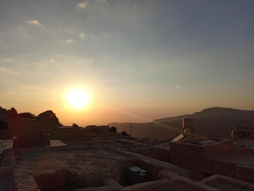 a sunset over the ruins of the acropolis at Dana Rose camp outdoor camping in Dana