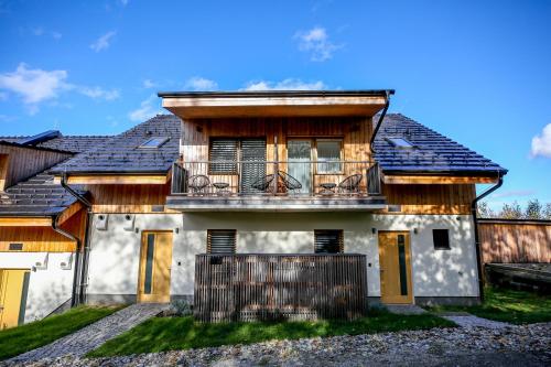 a house with a balcony on top of it at Apartmány Lipno Přední Výtoň in Přední Výtoň