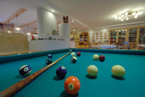 a pool table with balls in a room at Wellness e Resort Stella Delle Alpi in Ronzone