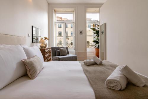 um quarto branco com uma cama com toalhas em Studio Sta no Porto