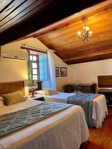 Katil atau katil-katil dalam bilik di Hotel Vila Nova do Príncipe