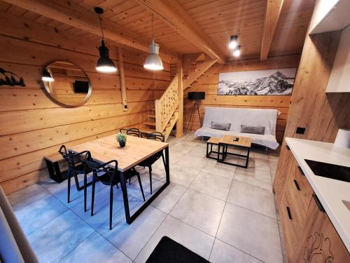 a room with a table and chairs and a bed at Skansen Holiday in Cholerzyn