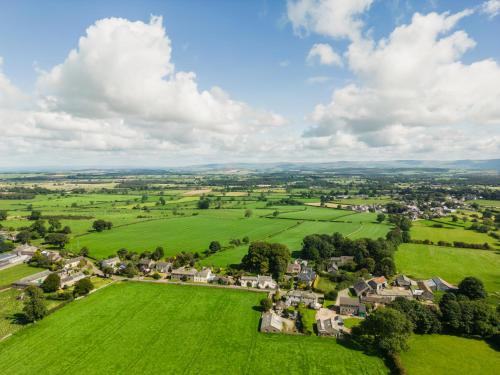 an aerial view of a village in a green field at Yew Tree: Historic Georgian Farmhouse, Ellonby in Ellonby