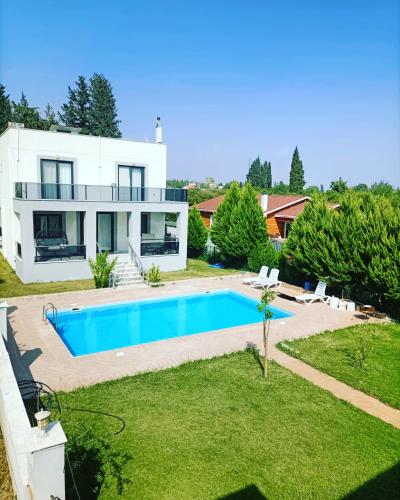 a house with a swimming pool in the yard at Holistic Balance 