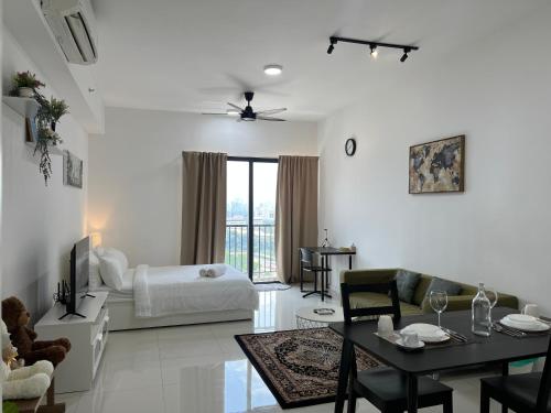 a white living room with a bed and a table at Cozy luxury couple studio apartment chambers kl klcc kl tower view in Kuala Lumpur