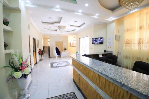 a lobby of a hospital with a bar with flowers at Gold Suite Hotel in Nakuru