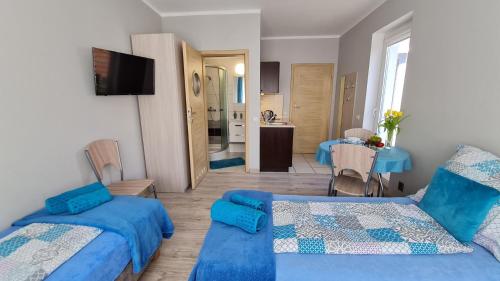 Katil atau katil-katil dalam bilik di Bela - apartamenty, pokoje z aneksami, parking
