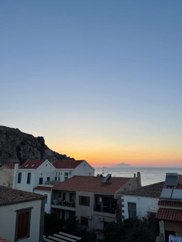a view of the sunset from the roofs of houses at Arxontiko Hotel in Mirina
