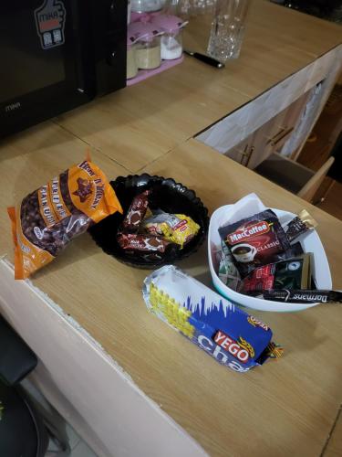 a counter top with snacks and a bowl of candy at G&G Homes Pipeline Nakuru in Nakuru